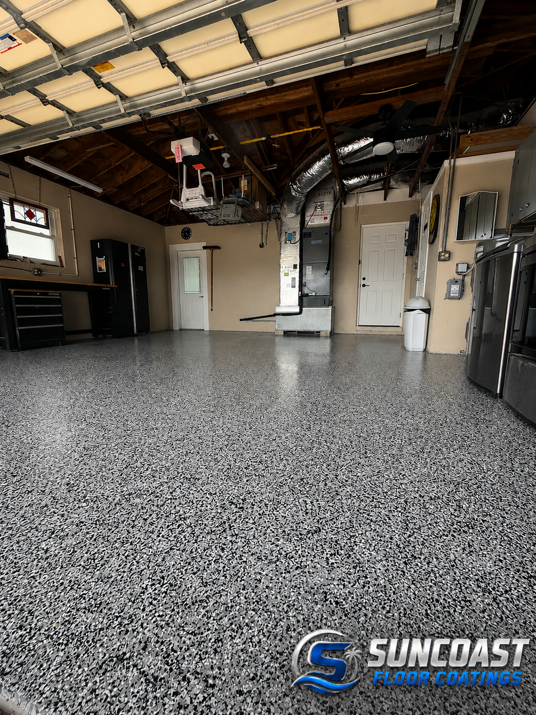 Completed gray full-flake garage floor coating in a clean residential garage